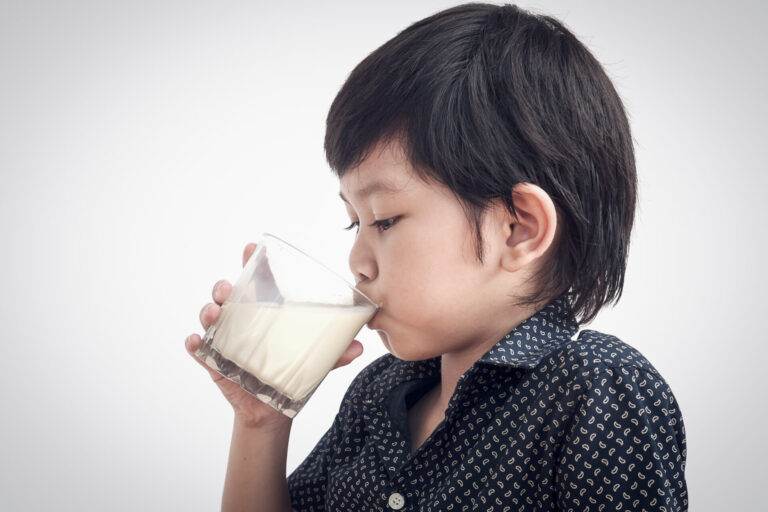 asian boy is drinking glass milk - Venus Milk